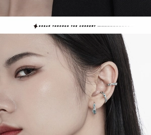 Close-up of irregular coral blue drop glaze silver ear cuffs set worn on female model