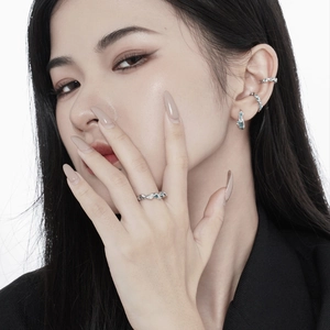 Irregular silver and blue gemstone jewelry set worn by a model in a close-up portrait view