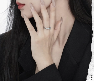 Irregular silver ear cuff with blue enamel lava texture shown on model for women