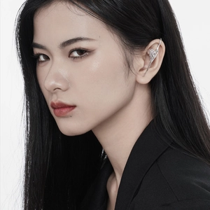 Chic silver liquid metal ear cuff with organic flowing design worn by a model