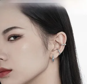 Detailed view of silver S925 coral blue ear cuff set showing fit on ear cartilage