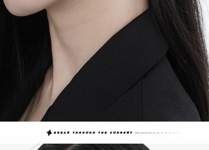 Close-up of black blazer lapel showing premium high-density twill fabric texture
