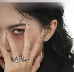Detailed view of S925 silver gothic ghost rings with teal enamel on female model hands