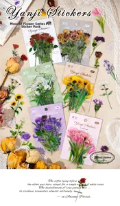 Artistic arrangement of floral PET stickers with dried flowers on beige fabric background