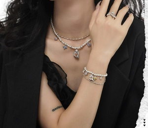 Macro view of multi-layer silver necklace with pearls and colorful gemstone pendants