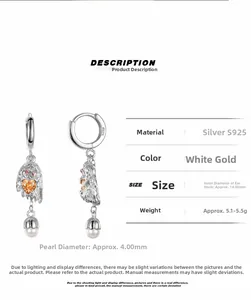Detail of S925 silver puppy earrings with orange heart zircon and white pearl drops