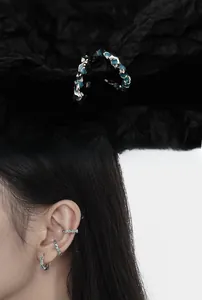 Macro shot and model view of silver lava texture ear cuffs with ocean blue enamel accents