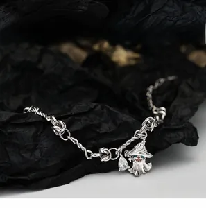 Macro detail of S925 silver bracelet featuring ghost witch hat and zircon drop charm