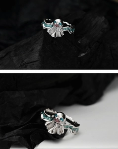 Macro shot of silver ghost ring with teal enamel eyes and unique dark gothic details