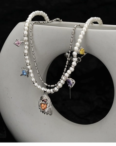 Close-up of S925 silver necklace with pearls, colorful gems, and animal charm pendant