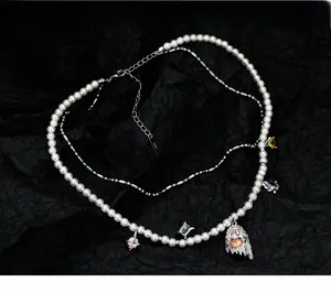 Detail of S925 silver necklace with ghost pendant, colorful zircons and white pearls