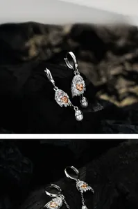 Detailed view of S925 silver ghost earring with orange heart gemstone and pearl drop
