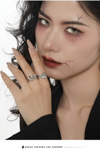 Close-up of S925 silver ghost rings with pink and blue stones on model's fingers