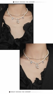 Double-layered necklace with white pearls and multicolored gemstones worn by a model