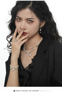 Fashion model wearing pearl necklace and colorful zircon jewelry set in street style