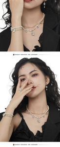 Detailed set of silver jewelry with pearls and colorful gemstones on a female model