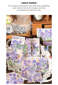 Detailed view of vintage purple floral scrapbooking paper with roses and butterflies