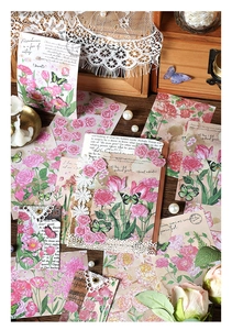 Detailed close-up of vintage pink floral stickers and butterflies on wooden background