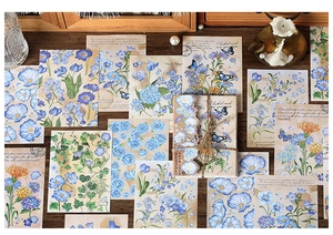 Vintage floral scrapbooking stickers with botanical prints and script on wooden background
