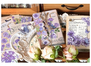 Close-up of vintage purple floral stickers with butterflies and elegant handwriting text