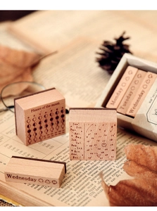 Macro shot of vintage wooden calendar stamps with moon phases and dates on old book pages
