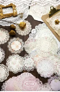 Close-up of vintage hollowed lace paper on wood background for scrapbooking decor