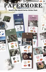 Detail of artistic paper stickers featuring nature scenes and coffee for scrapbooking