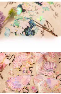 Detail view of PET stickers showing iridescent lotus and butterfly laser patterns