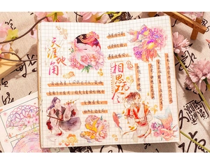 Close-up of vintage PET stickers with holographic ink and Chinese calligraphy on grid paper