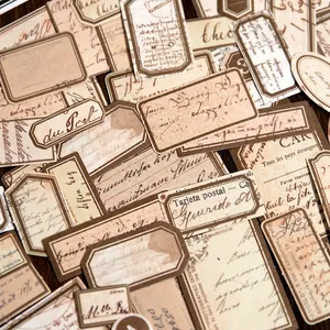 Vintage paper stickers set featuring antique labels on dark wooden table background