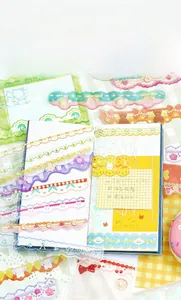 Close-up of cute strawberry and bunny stickers on an open notebook with soft pastel tones