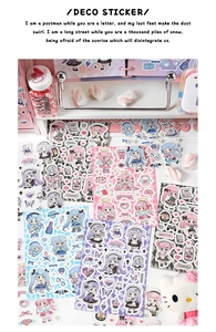 Detail of cute anime girl stickers on a desk with a mechanical keyboard and storage rack