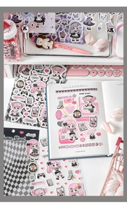 Close-up of pink anime girl stickers with retro game consoles for DIY journals