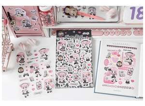 Close-up of anime gamer girl stickers with gamepads and headphones for DIY journal deco