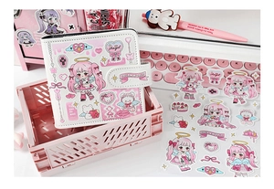 Kawaii pink binder and sticker set with cartoon girl design on a desk setup
