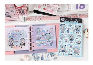 Detailed view of anime rock girl stickers on binder with guitar and heart motifs