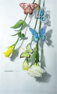 Detailed close-up of decorative butterfly jewelry stickers on delicate white flowers