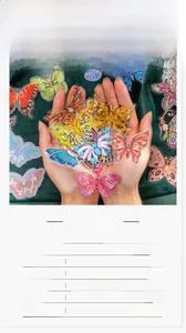 Detail view of crystal butterfly stickers on green velvet with a PET material size chart