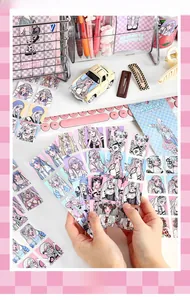 Close-up of Girl's Prayer anime sticker sheets on a creative vintage desktop setup