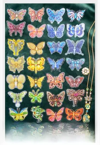 Detailed view of jewelry-style butterfly stickers on dark green velvet background