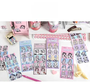 Flat lay of Japanese anime girl stickers with pink stationery on a white desktop