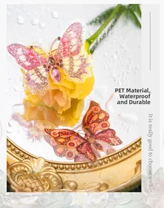 Close-up of waterproof PET butterfly stickers in pink and orange on floral background