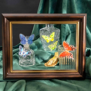 Artistic collection of crystal butterfly stickers on glass bottles with vintage wood frame