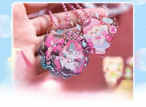 Close-up of glittery cartoon acrylic keychain with pink chain and cute girl character