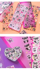 Close-up of cute anime stickers with glitter finish and a heart-shaped storage box
