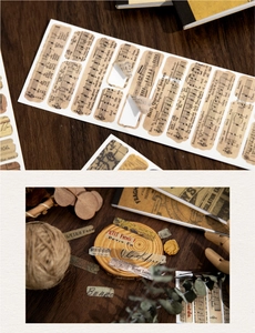 Detail of vintage sheet music and old newspaper scrapbooking stickers on wood