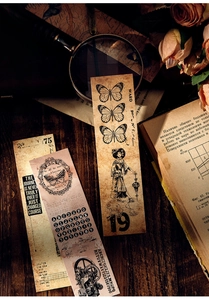 Detail of vintage bookmarks featuring butterfly and Victorian illustrations on dark wood