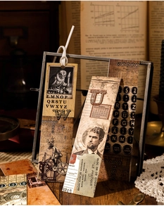 Detailed view of vintage bookmarks featuring owl and typewriter illustrations on cardstock