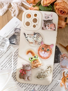Detailed view of cute cat printed phone case with vintage floral and paper background