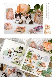Detail of vintage cat PET stickers applied on a journal with dried flowers and retro paper